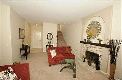 Living room looking towards the front door and upstairs. There i