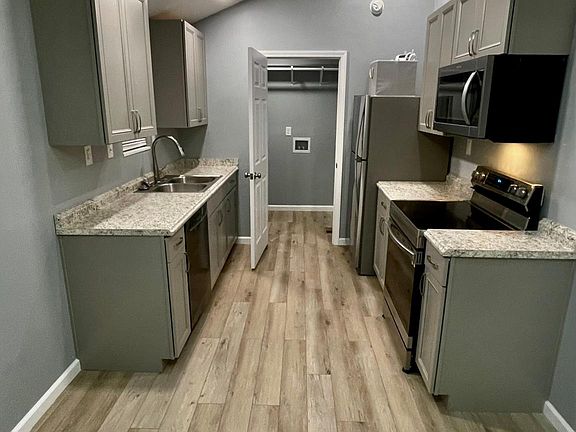 The kitchen includes the refrigerator, oven, dishwasher & microwave. The doorway, shown in the picture, enters the laundry room - washer & dryer are NOT included with the rental.