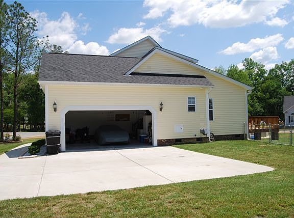 View of the side of the home with 2 car garage.
