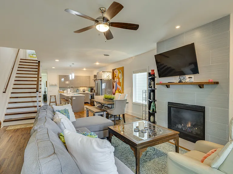 The living room is thoughtfully stocked with books, magazines, board games, and more, offering plenty of ways to relax, unwind, and enjoy quality time together.