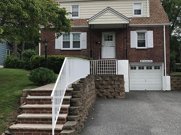 FRONT OF HOUSE AND 3 PARKING SPACES