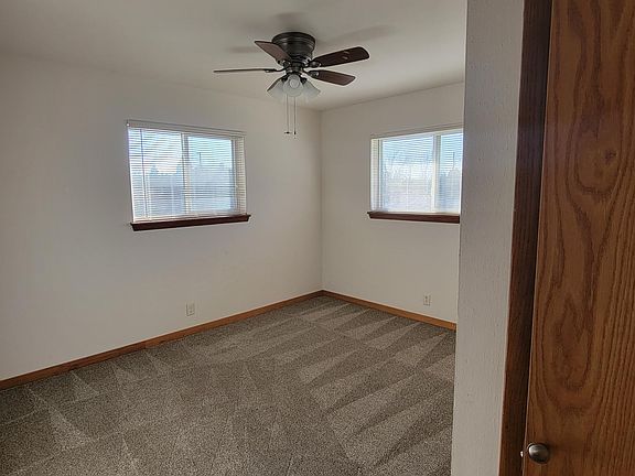Master bedroom with carpeting, ceiling fan and linen closet.