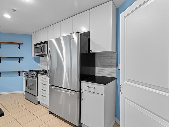 High-end cabinetry & stainless steel appliances including a gas range