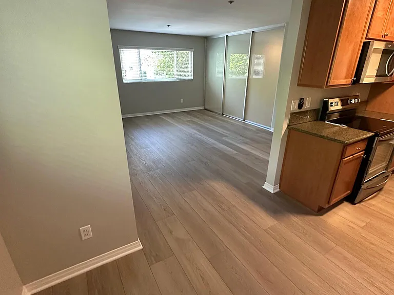 Looking from the dinette area into living and kitchen.