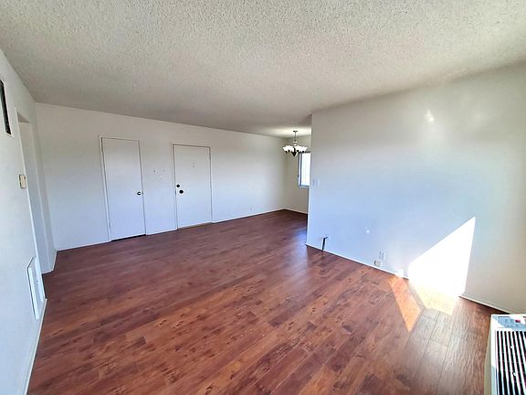 Living room, front door, & coat closet