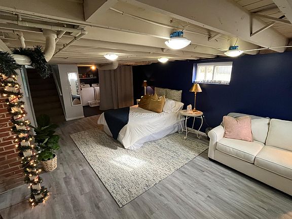 Alternate view of refinished basement - washer/dryer behind the grey curtain.