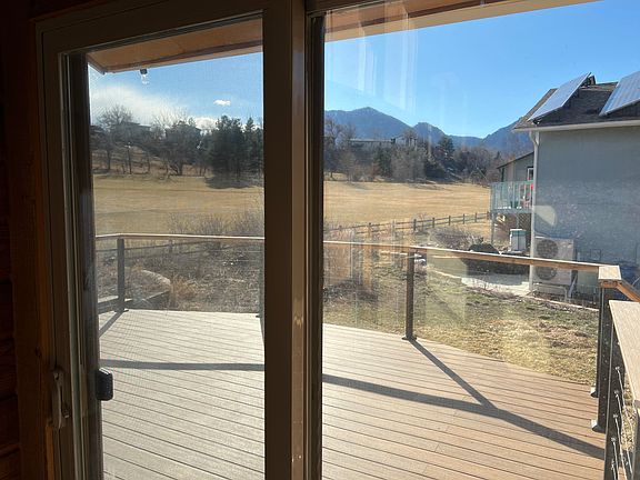 View from living room to deck and mountains