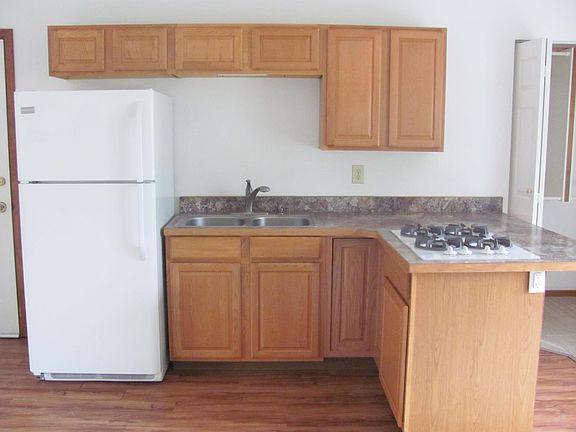 Kitchen with full size fridge and electric range top