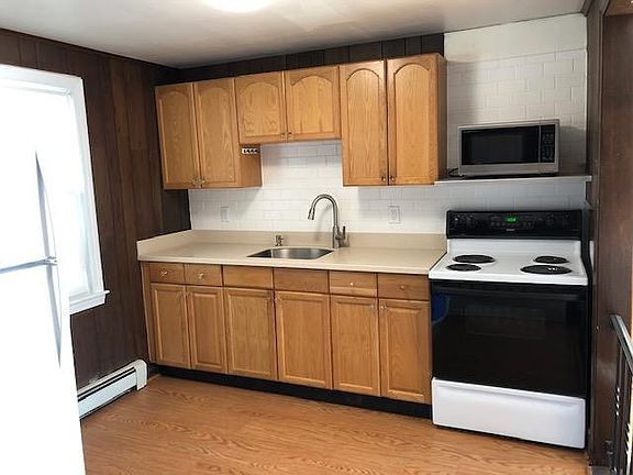 Recently updated kitchen; corian counter-top, stainless steel sink, subway tile backsplash.