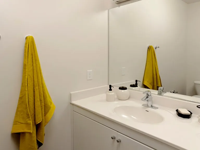 Urban bath with white cabinetry, white laminate countertops, and hard surface flooring