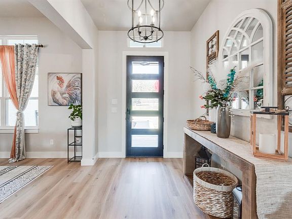 Entryway with light hardwood / wood-style flooring and a notable chandelier