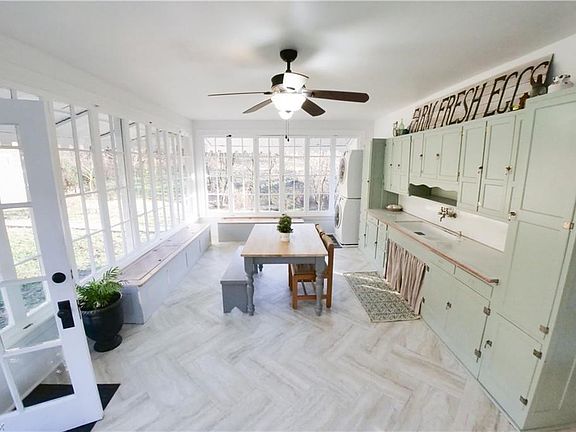 Huge summer kitchen with original sink and cabinets.