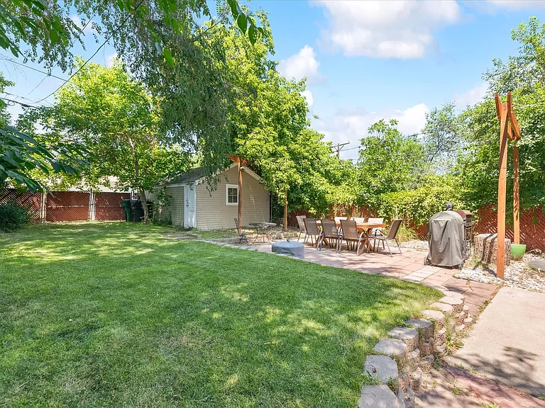 Backyard, patio with included cafe lights, and 1-car garage / storage