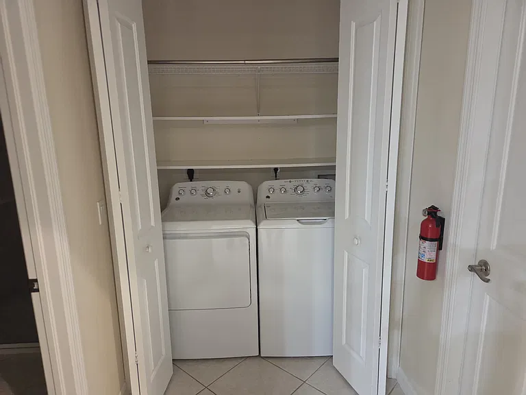 Laundry room with furnished washer and dryer located next to #2 bathroom