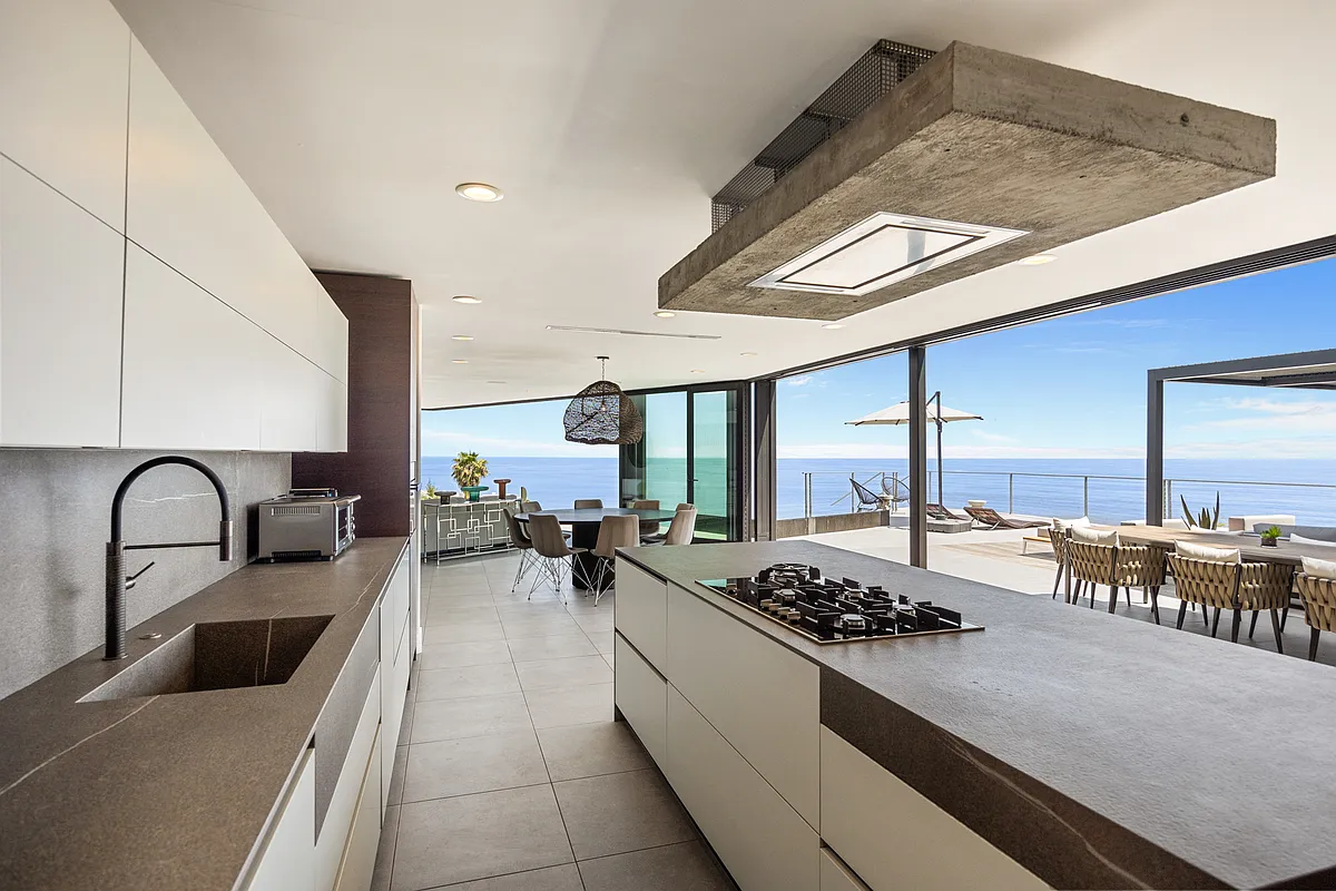 Cook gourmet meals in a European-style kitchen equipped with premium Miele appliances. - 3947 Ridgemont Dr