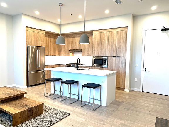 Spacious kitchen with brand new appliances, quartz island and open concept