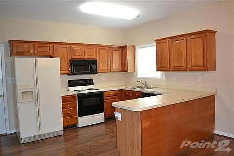 Spacious kitchen with pantry and built in desk.