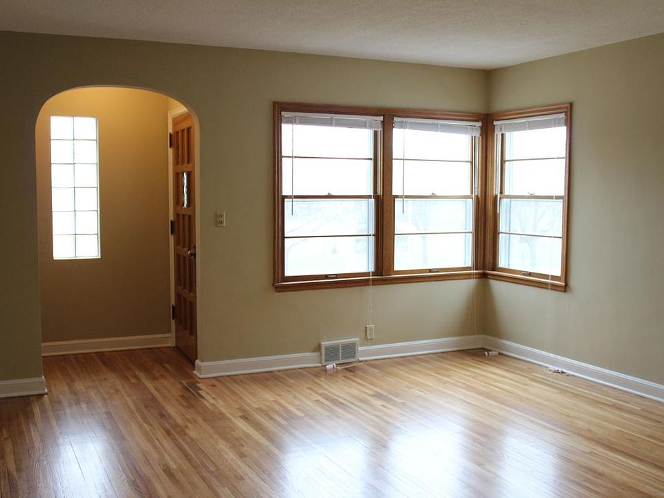 Living room overlooking Pearl Park. New windows installed in 2021. Hardwood floors refinished in 2017.