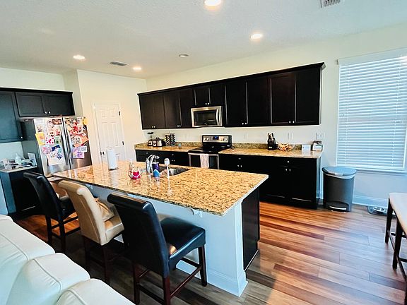 Kitchen with large walk in pantry. Stainless steel appliances, granite countertops and oversized island