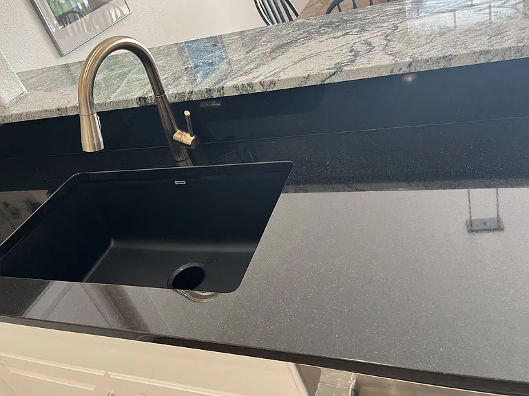 New granite and backsplash in kitchen with Blanco sink.