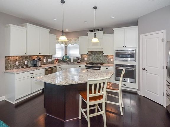 CUSTOM FLOORING, CABINETS, LIGHTING, BACKSPLASH & UPGRADED APPLIANCE PACKAGE!
