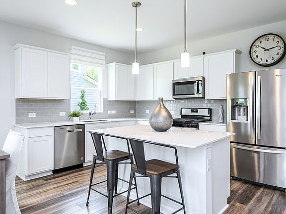 Package A Kitchen with beautiful white cabinets and gray backsplash