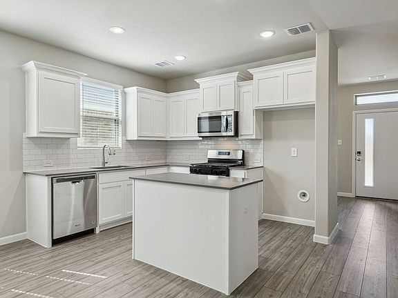 Kitchen in the Pearl home plan by Trophy Signature Homes - REPRESENTATIVE PHOTO