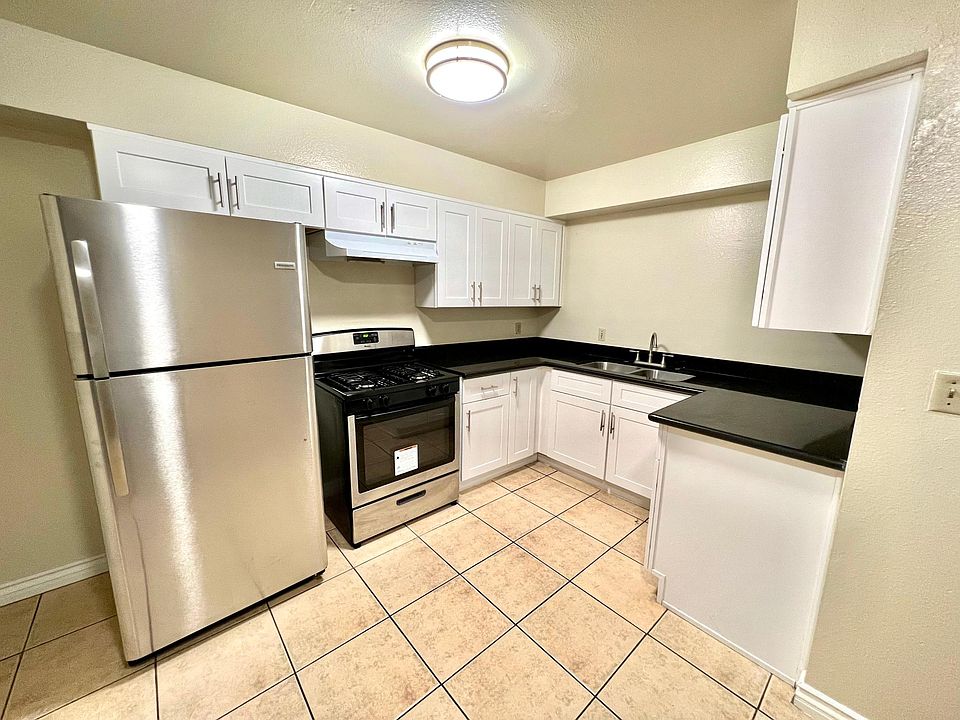 Kitchen including newly remodeled cabinets with stainless steel refrigerator and stainless steel stove/oven
