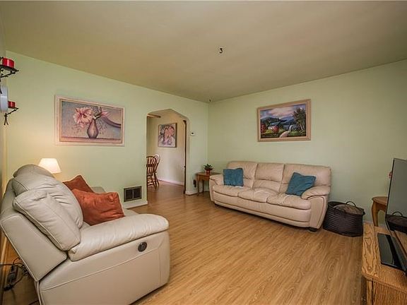 Easy to clean laminate wood flooring covers the living and dining room floors.