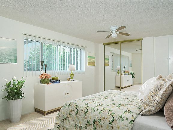 Staged bedroom with large closet and window.