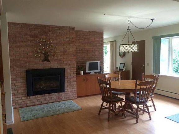 Large, spacious Dining area - could easily have a small sitting area in front of the cozy gas fireplace too!br /Laminate wood flooring is featured and easy to take care of