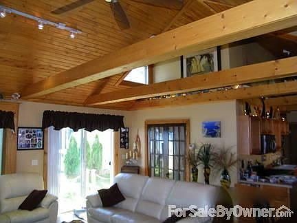 Soaring Ceilings and Dormer Windows : Many dormer windows for added natural light. The beams add to 