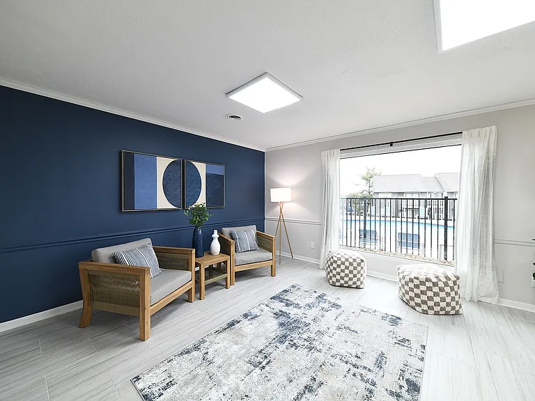 Experience tranquility in this elegantly designed living room with a poolside view.
