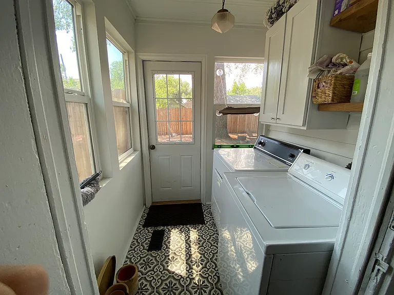 Laundry room off the kitchen that leads into the backyard. Washer/dryer included.