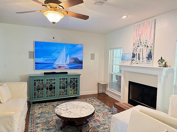 Stylish living room featuring a cozy fireplace, modern entertainment setup, and bright natural light_perfect for relaxing and unwinding.
