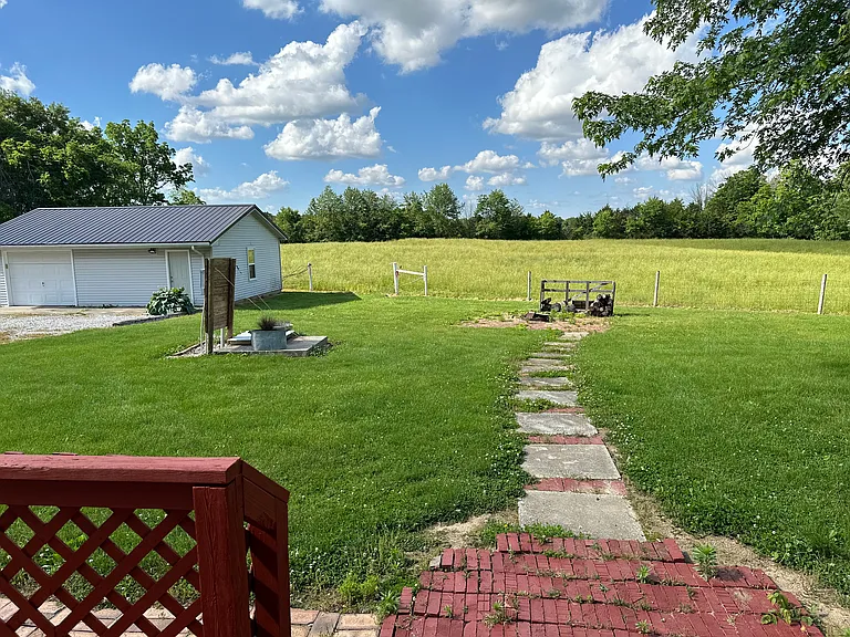 Backyard and garage with workshop. Fenced backyard and neighbor's pasture.