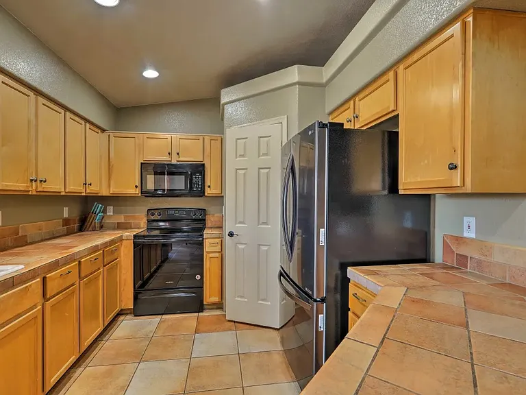 Large spacious kitchen. Refrigerator, freezer. Stove, microwave, garbage disposal, dishwasher. Lots of cabinets and pantry.