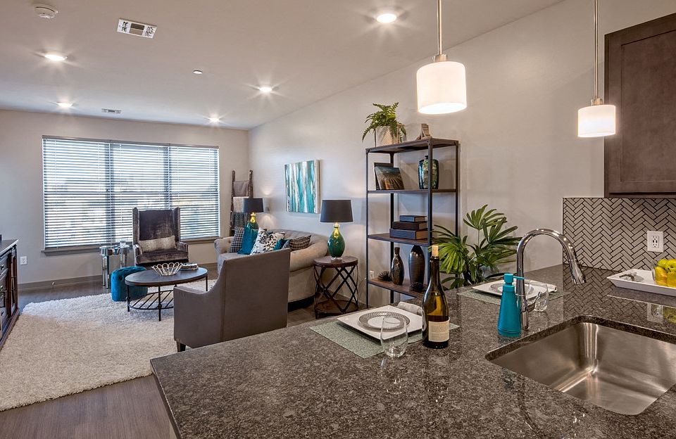 Modern Comfort: Open floor plan between kitchen and living room. (Photo Credit: David Miller)