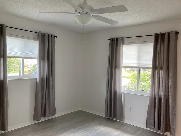 Secondary bedroom with luxury vinyl flooring and cellular blinds