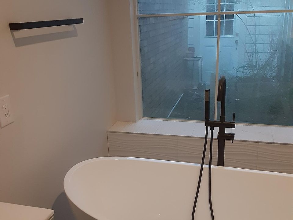 Master bath with standalone tub. Walk-in shower and walk-in closet to the right of the tub.