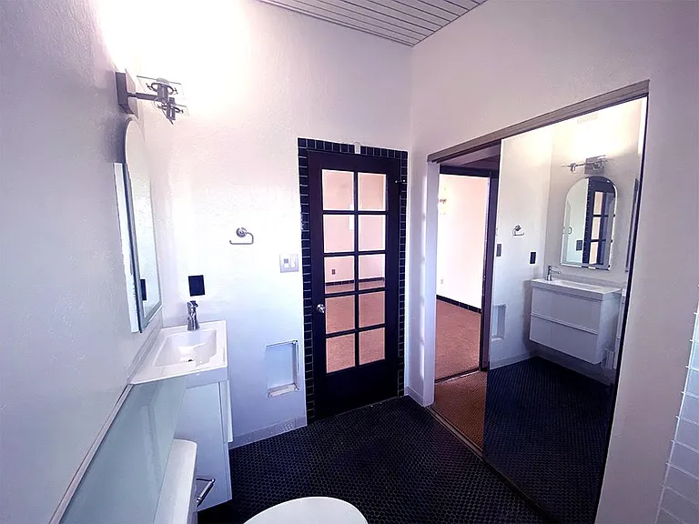 The sliding mirror door in the bath passes through to the walk-in closet.