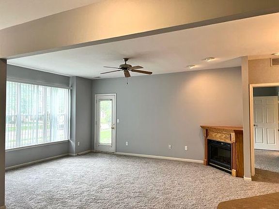 large open living room with corner gas fireplace