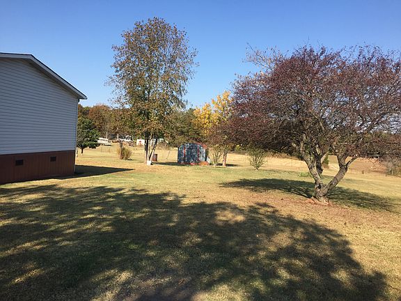 Driveway view of backyard 
