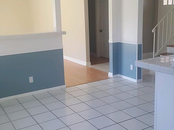 Kitchen looking into living room, front entrance and down st