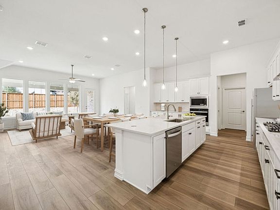 Open-concept kitchen and gathering room in the Azle floorplan with seamless flow for entertaining.