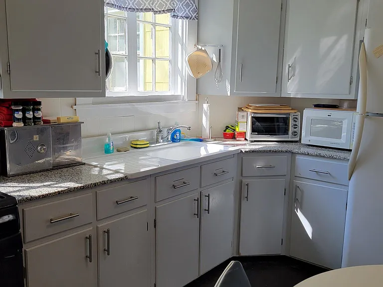 BIG Eat in Kitchen. Sunny. New Sept '24 gas stove. Windows. Washer and Dryer. French Fridge. Granite counters. 1920 Barn Find Farm Sink.. Dark Hardwoods. Leads to covered patio overlooks big grassy back yard with mature trees. Fenced patio-small yard.