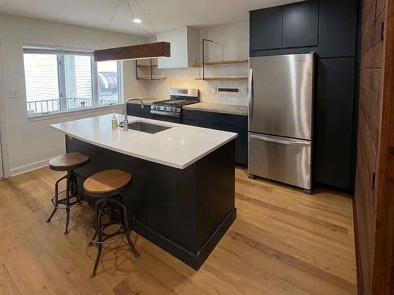 Island sink, stainless appliances, pantry on the right-hand side of refrigerator