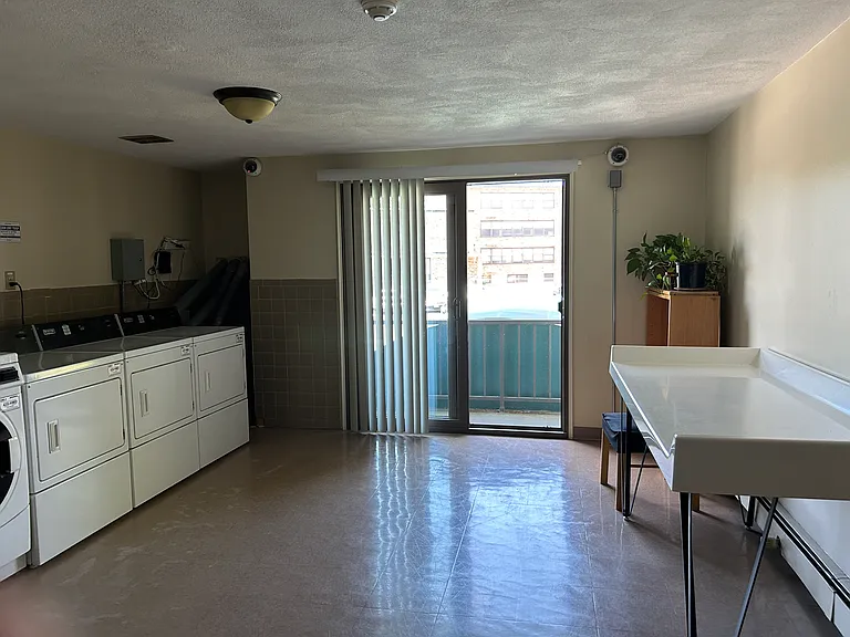 Laundry Room - Clean with Balcony and Folding Table and Cameras too