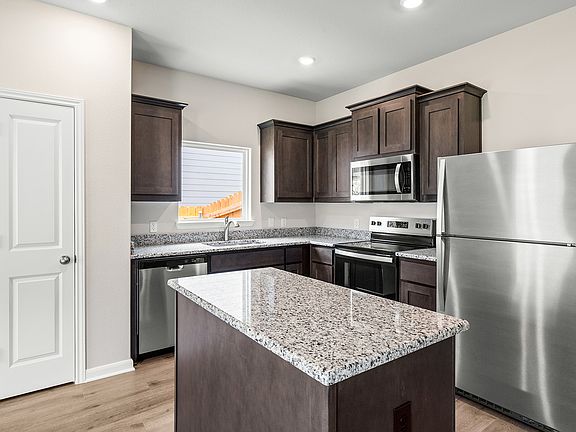 The kitchen has sprawling granite countertops.