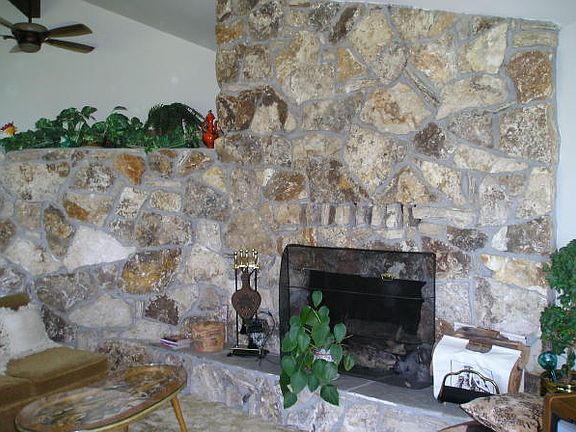 Great stone fireplace & vaulted ceilings in open style living & dining